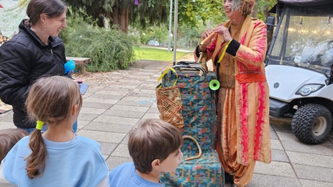 ילדים צופים בהופעת יחיד של שחקנית מחופשת.jpg