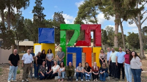 מנהלי בתי הספר ראשת המועצה וצותת אגף החינוך בתמונה קבוצתית ליד פסל שכתוב בו תקווה.jpeg